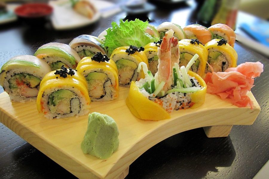 Colourful maki rolls served on a wooden board